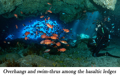 Overhangs
and swim-thrus among the basaltic ledges